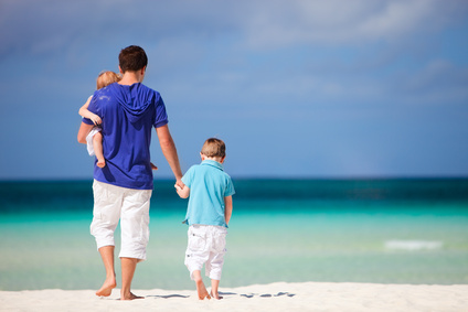 Happy father with his two kids on tropical beach vacation