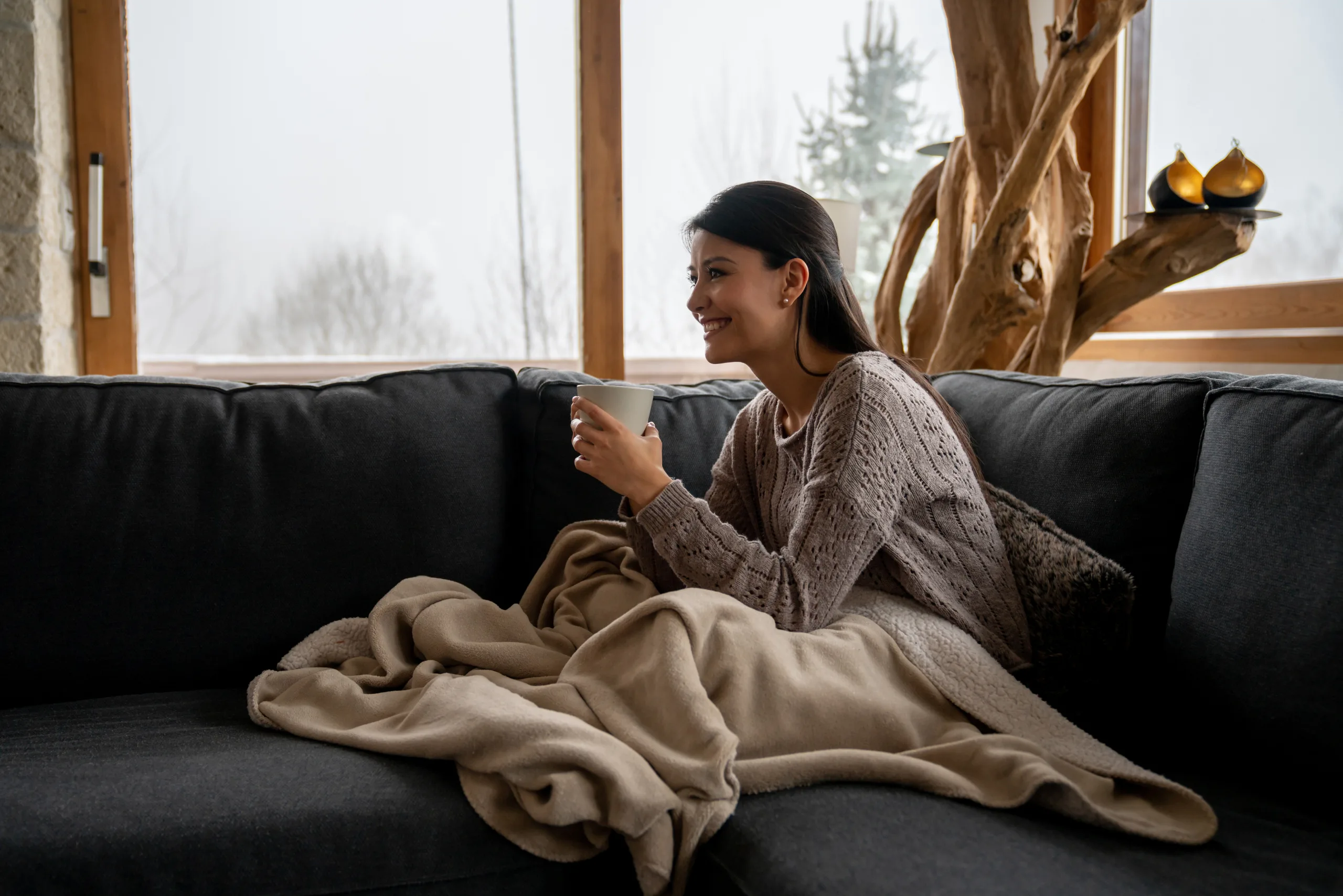 Happy Woman At Home Drinking A Cup Of Coffee