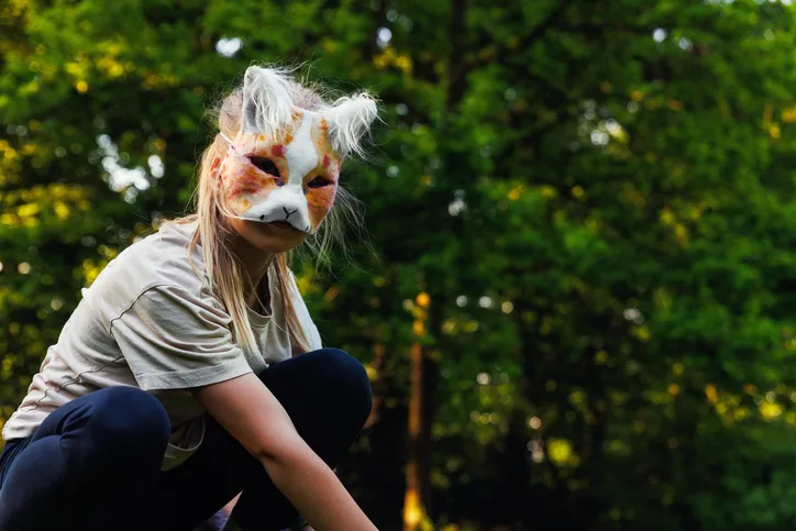 Cute Young Little Kid Girl Wear Cat Furry Mask Enjoy Have Fun Playing Outdoors In Forest Street Park. Children Therian Wild Animal Character Trendy Fan Culture. Teenager Social Expression Hobby