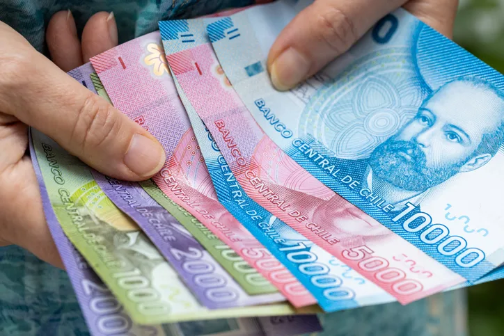 Woman Holding Chilean Money, Various Peso Banknotes, House Budget Concept