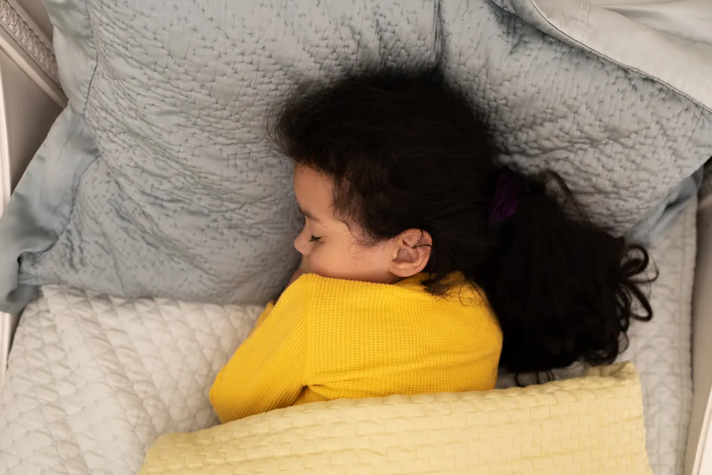 Young Mixed Race Girl Soundly Sleeping Under Weighted Blanket