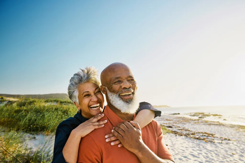 Active Mature African American Couple Enjoying Retirement And Each Other’s Company At The Beach.