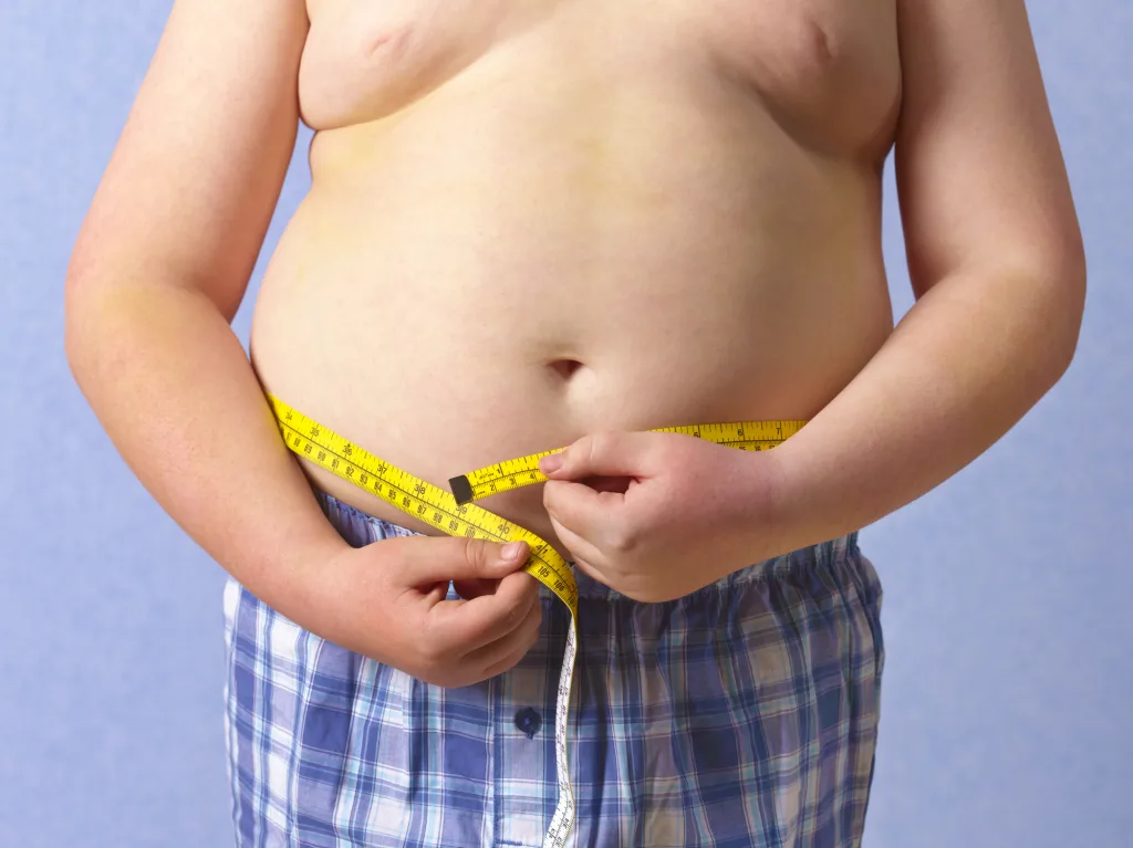 Overweight 12 Year Old Boy Measuring Himself