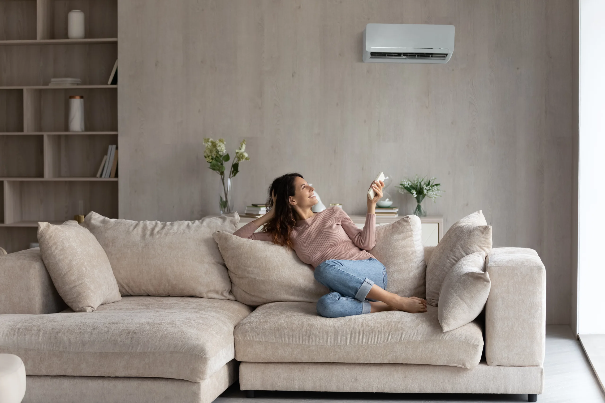 Relaxed Young Hispanic Woman Turning On Air Conditioner.